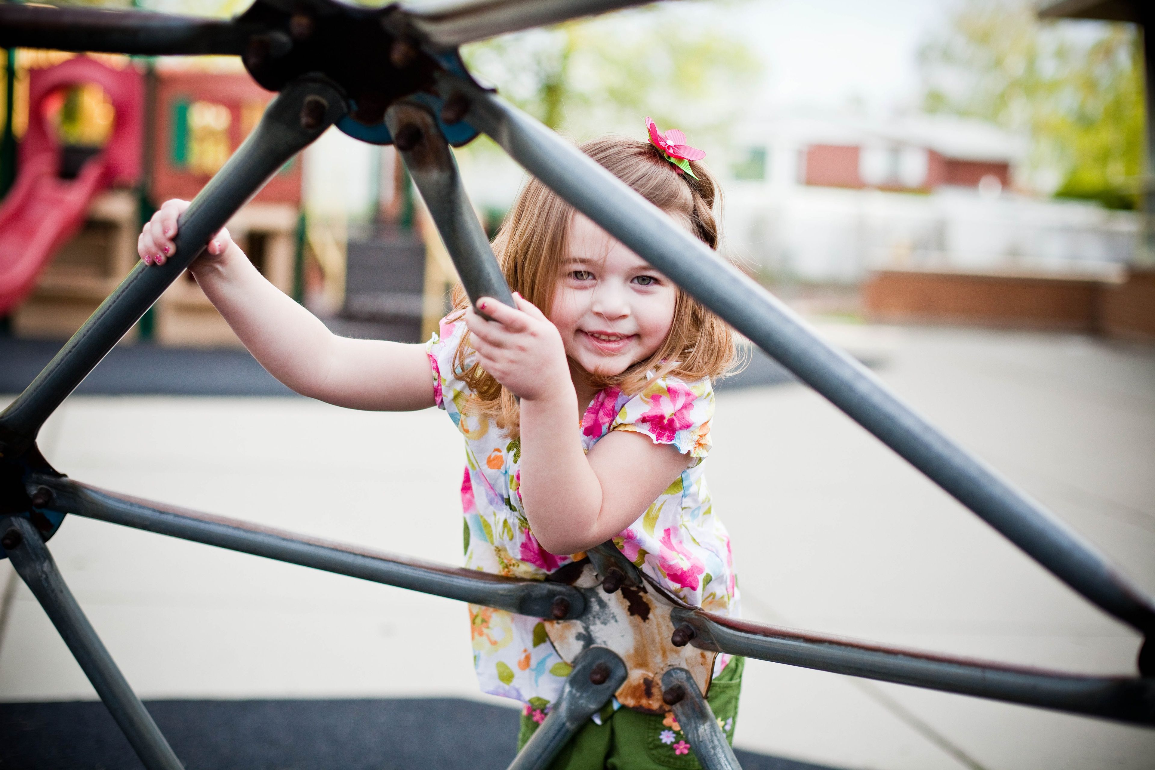 A little girl plays on a playground.