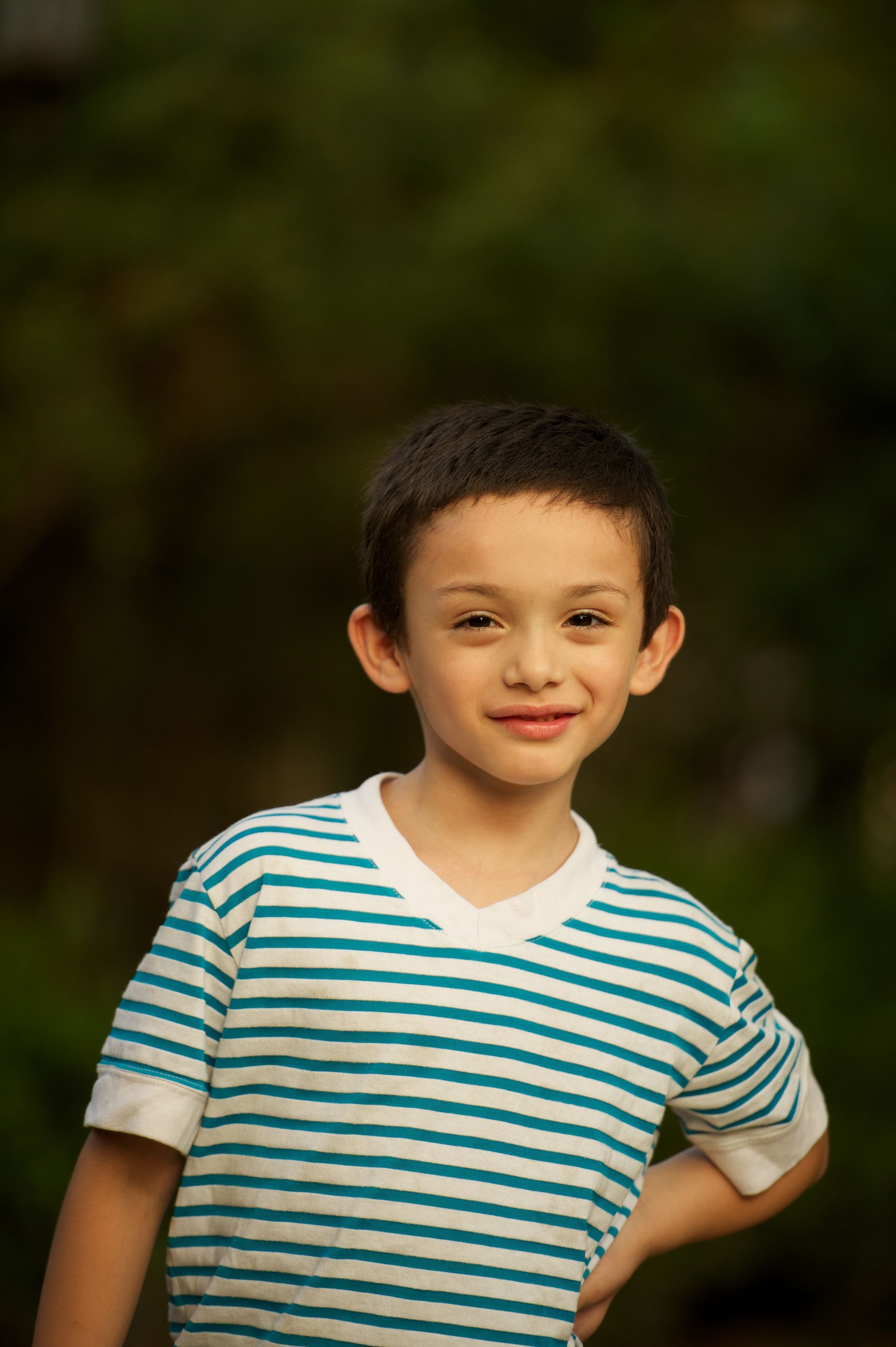 A portrait of a young boy in a striped shirt.
