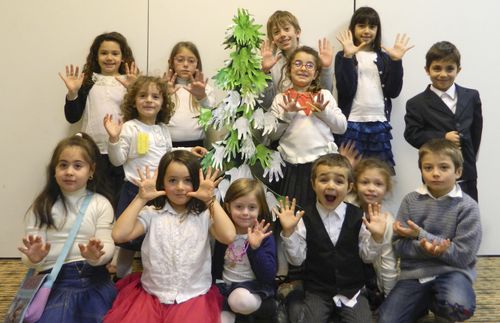 Primary children with helping hands Christmas tree