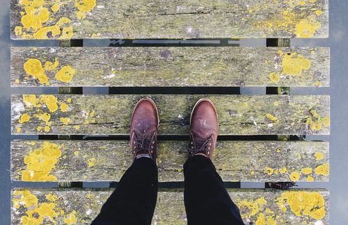 feet standing on a boardwalk