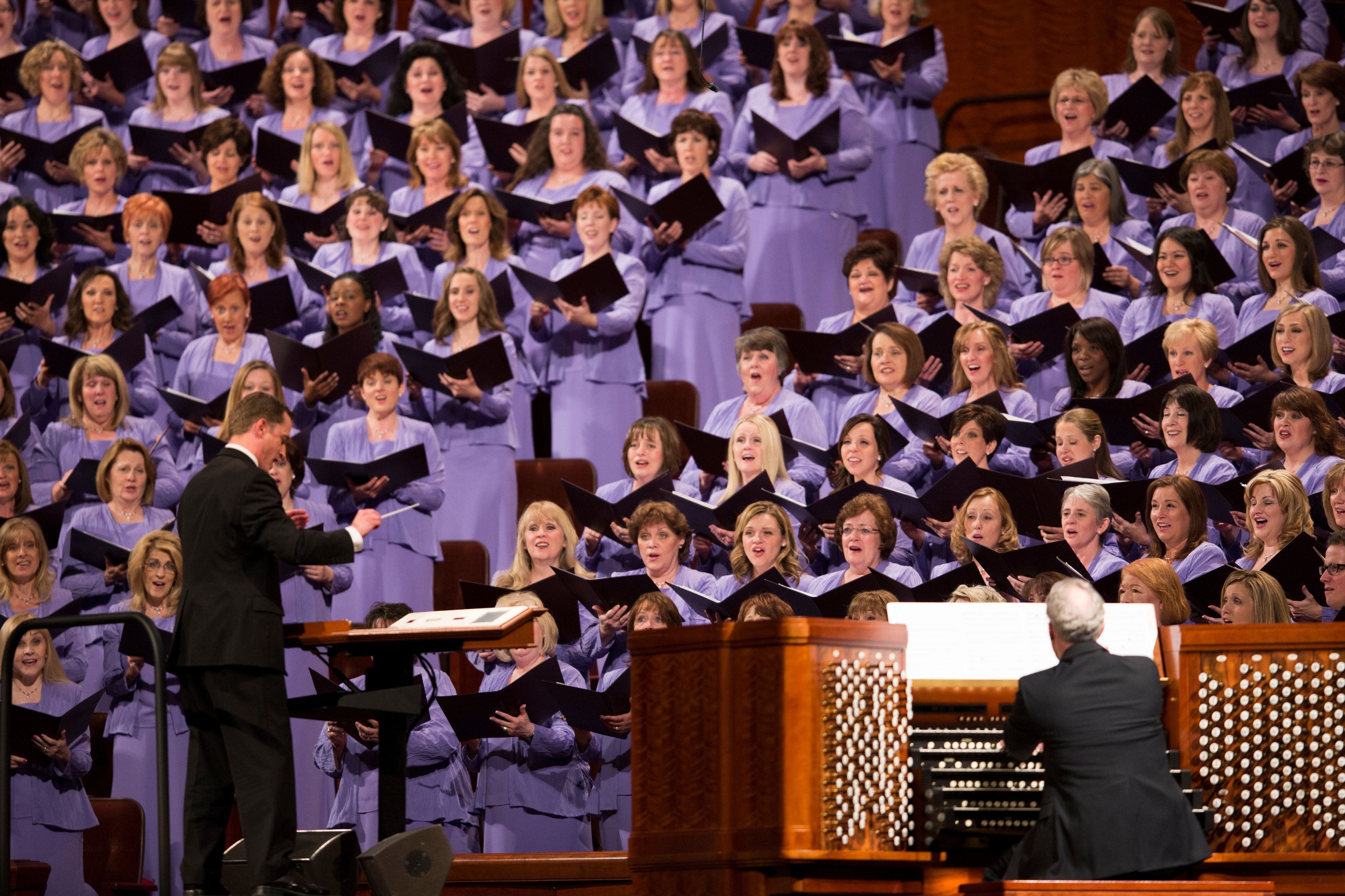 Ryan Murphy stands on the stage of the Conference Center to conduct the choir at the April 2013 general conference.  