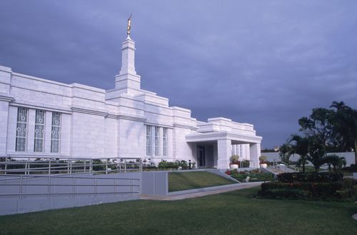 A side view of the Mérida Mexico Temple front entrance, with a wheelchair ramp, on an overcast day.