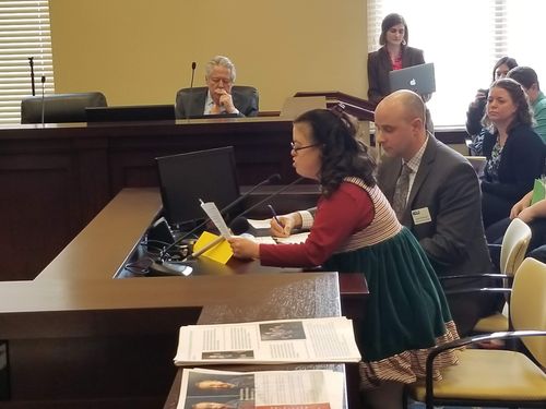 woman testifying at legislative hearing