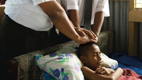 sick boy receiving priesthood blessing