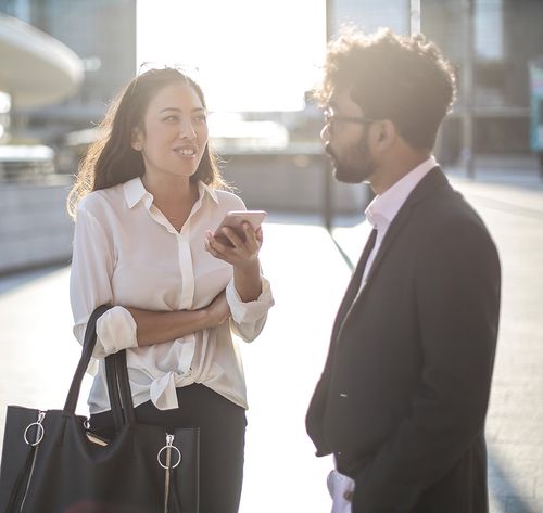 business people talking at a train station