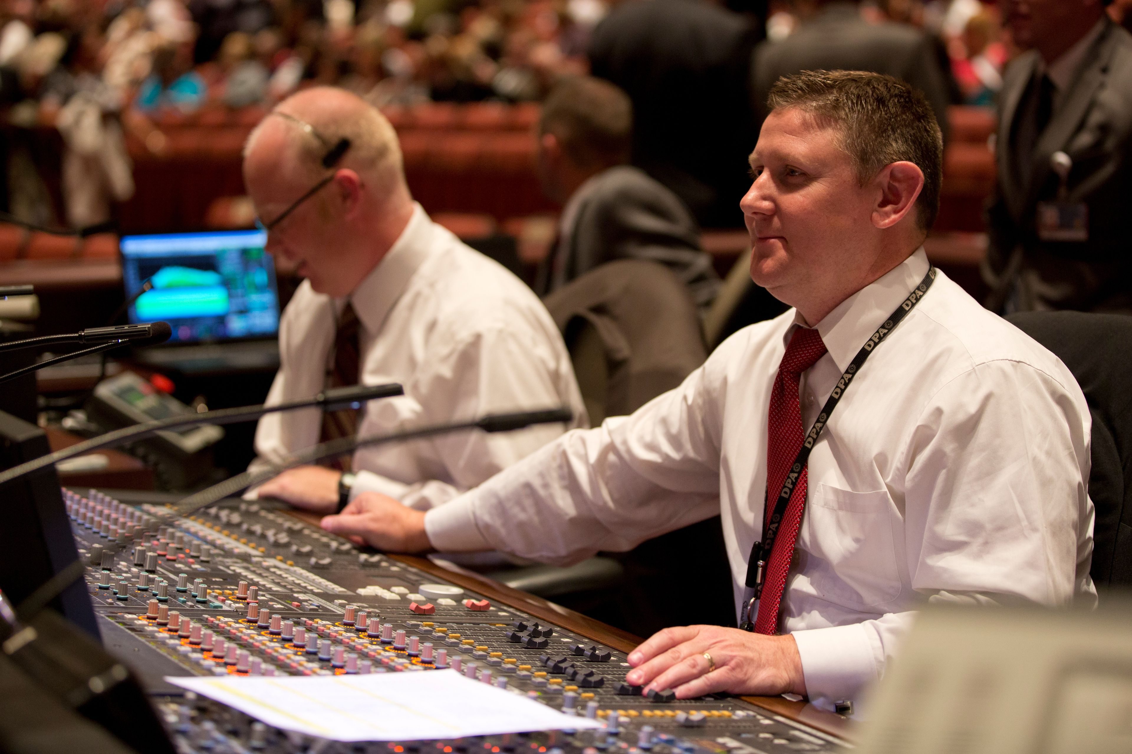 Two men working for the technical crew at general conference.   