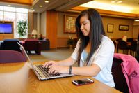 youth typing on computer