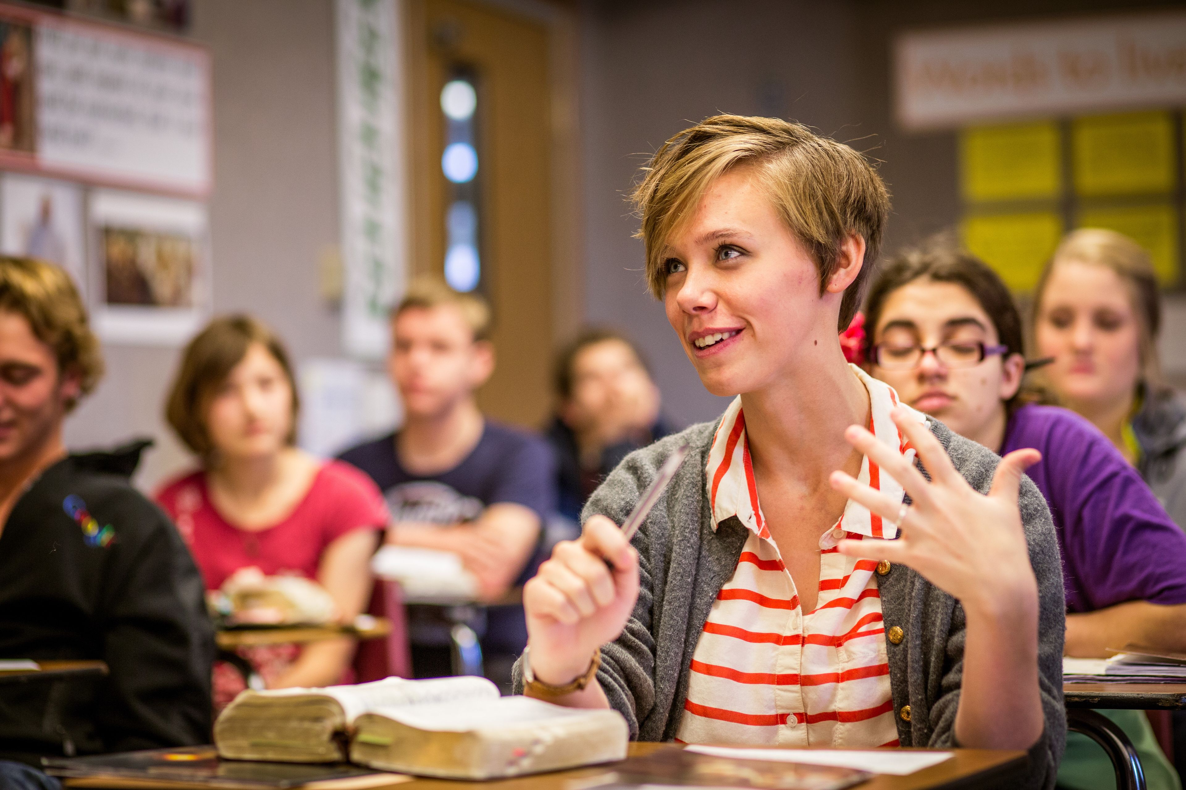 A young woman speaks up during seminary class.