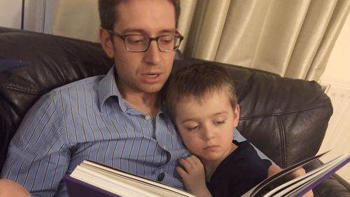 father and son reading together