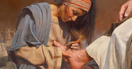 woman wiping Jesus’s feet with her hair