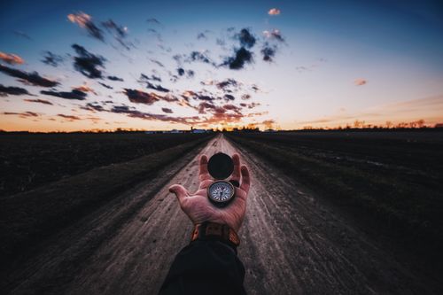 hand holding a compass