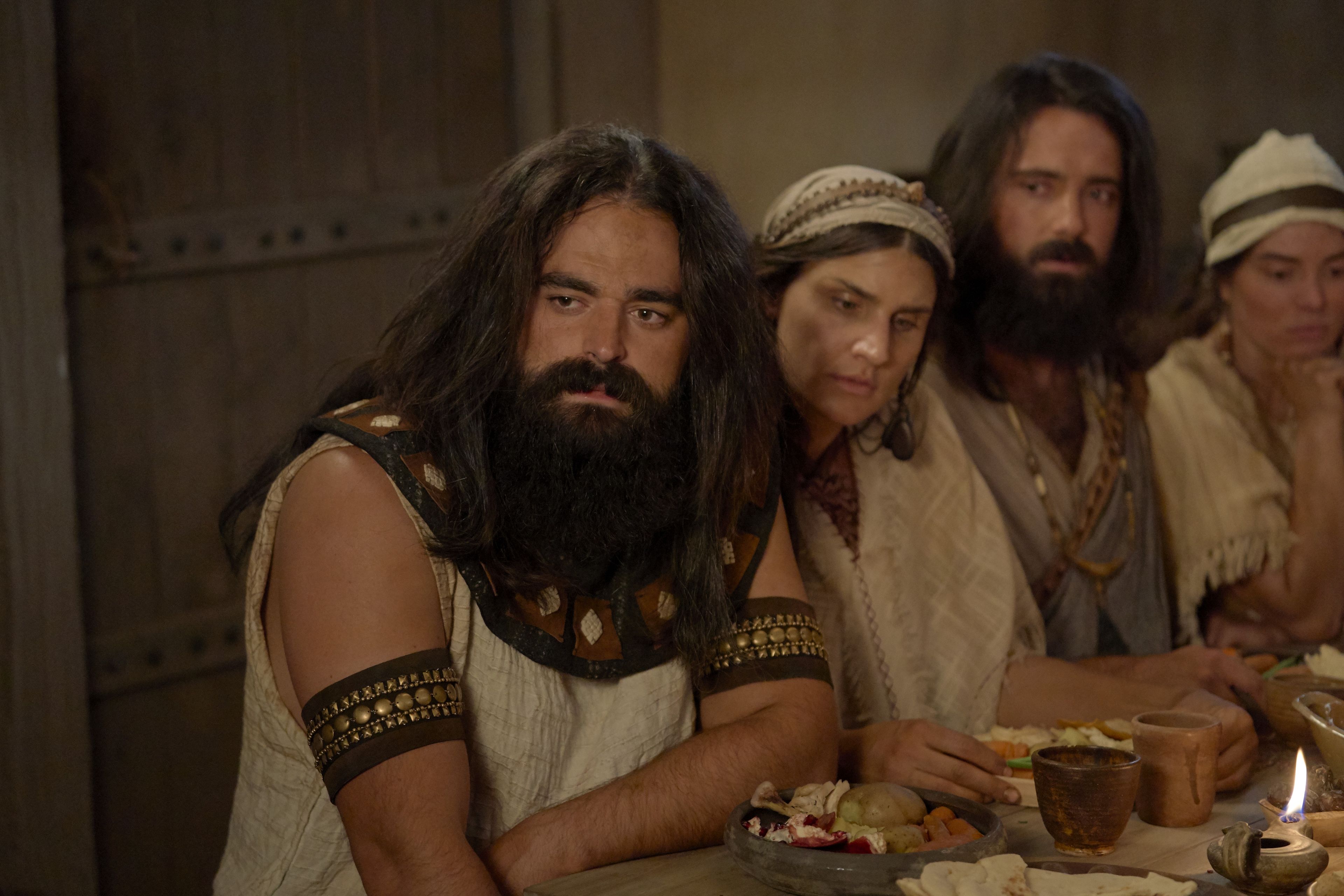 Laman and Lemuel eat dinner with their family.