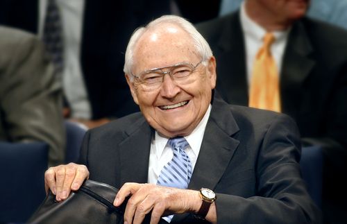 Elder L. Tom Perry sitting in a chair during a meeting.  He is smiling at the camera.