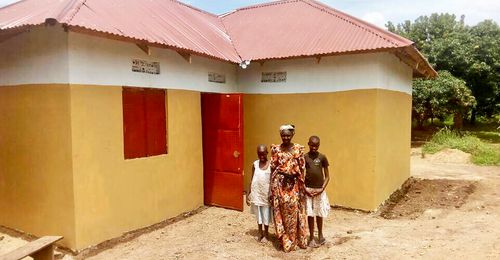 family in front of a house