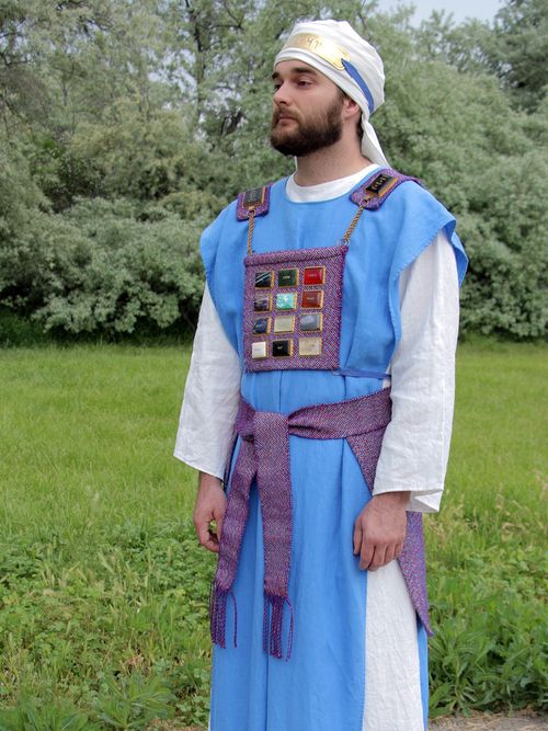 A man dressed in the costume of a High Priest at the model of the Jewish Tabernacle.