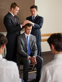 young man being ordained to an office in the priesthood