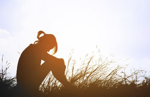 woman sitting in the grass