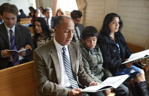 family sitting in sacrament meeting