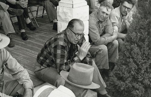 President Ezra Taft Benson speaking to men on a porch