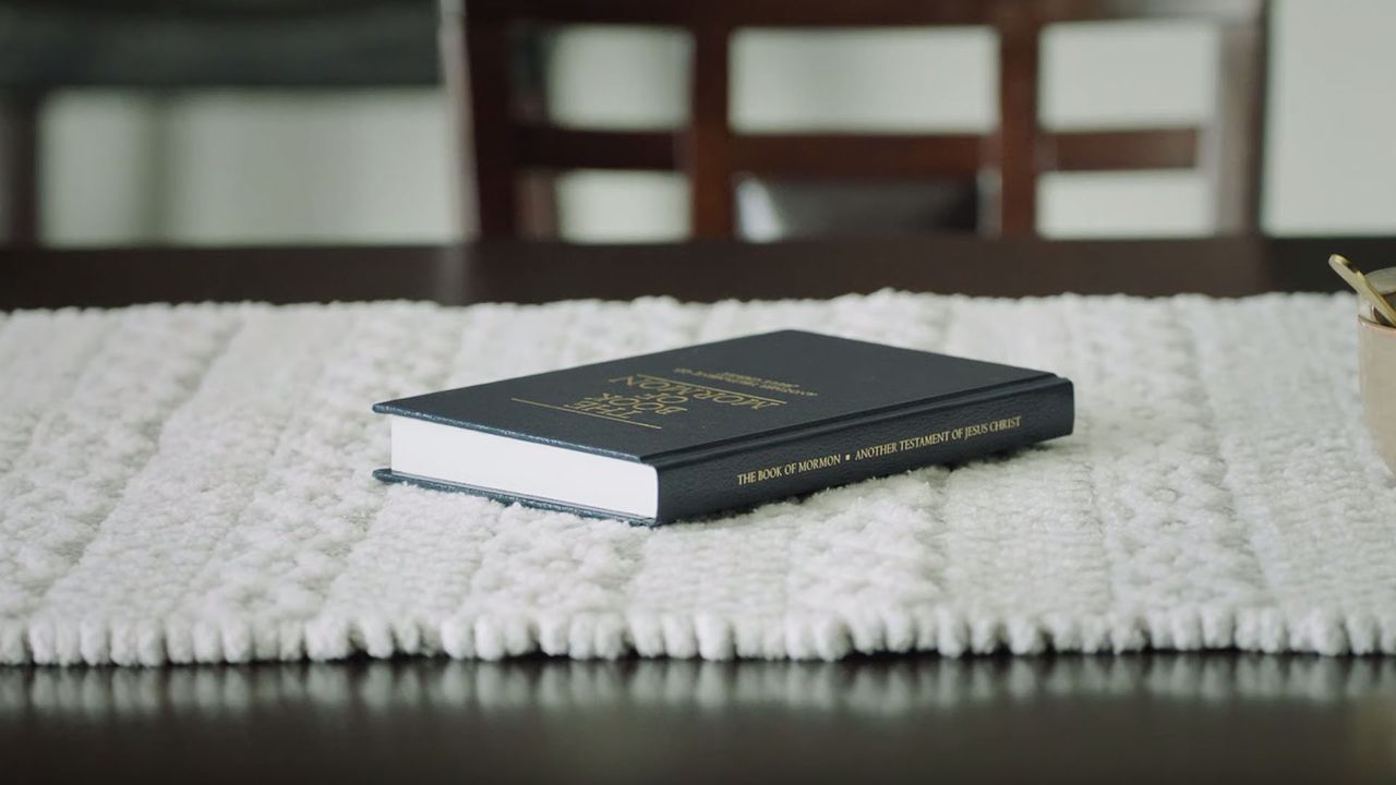 A copy of the Book of Mormon lays on the table