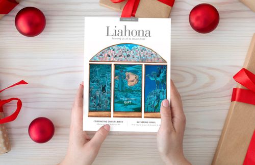 hands holding a Liahona magazine