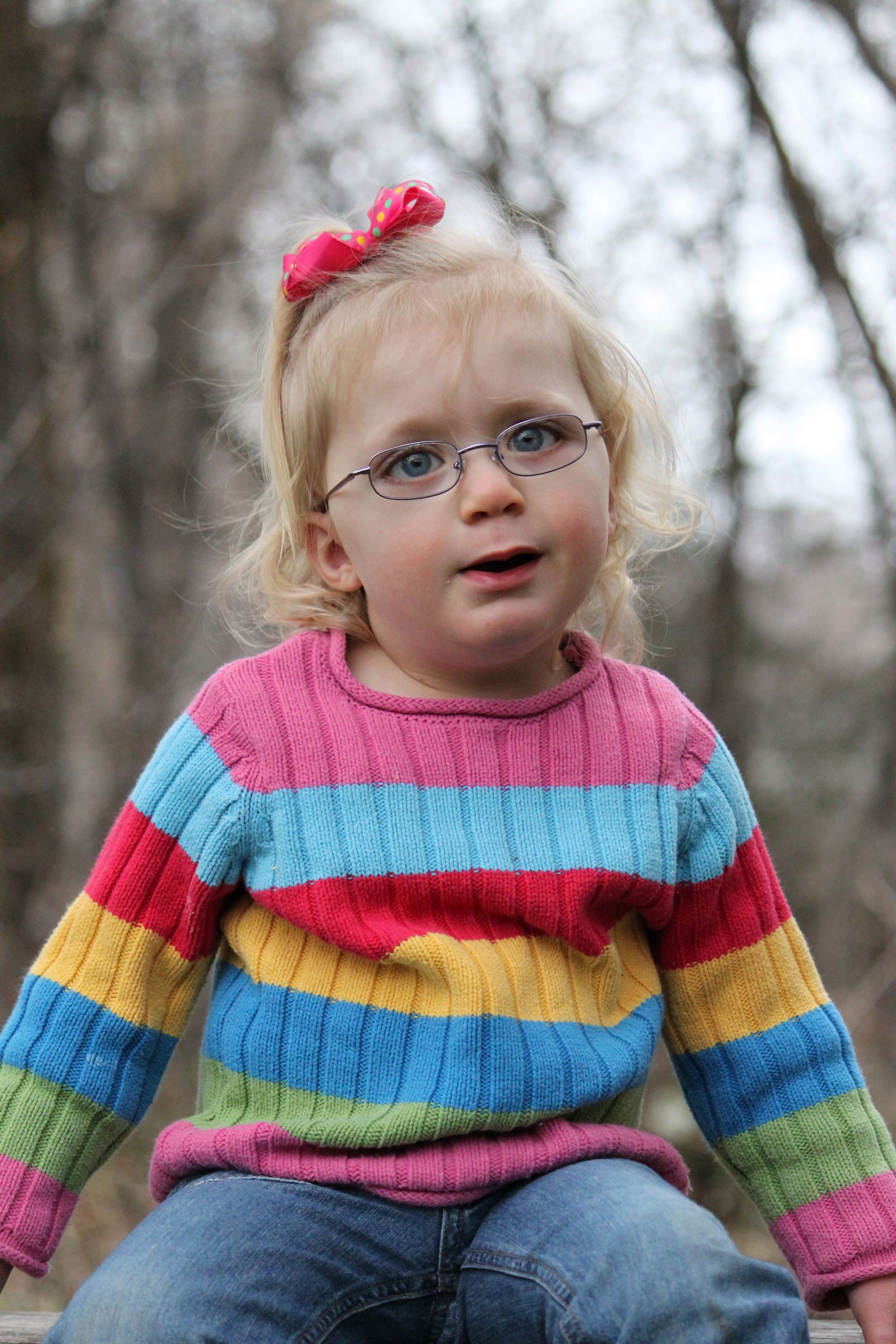 A young girl with glasses.