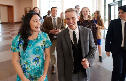 young adults walking and laughing together