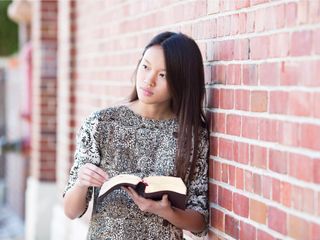 young woman holding scriptures