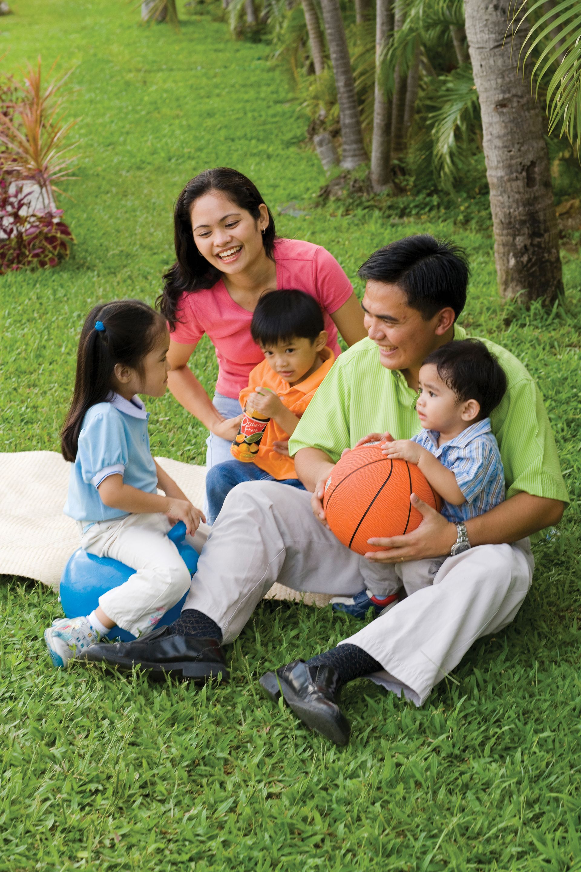 A family playing with a basketball together.