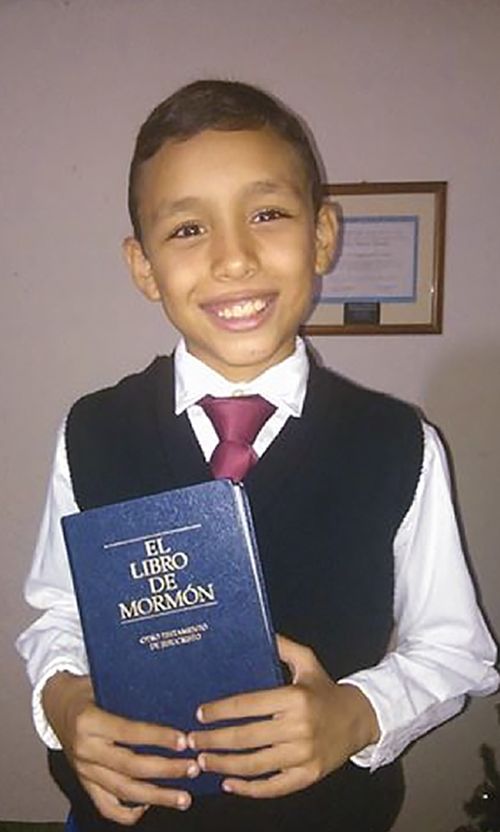 boy holding Book of Mormon