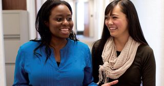 two young adult women talking