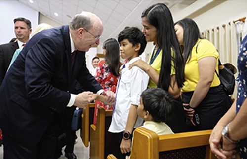 Elder Cook speaking to child