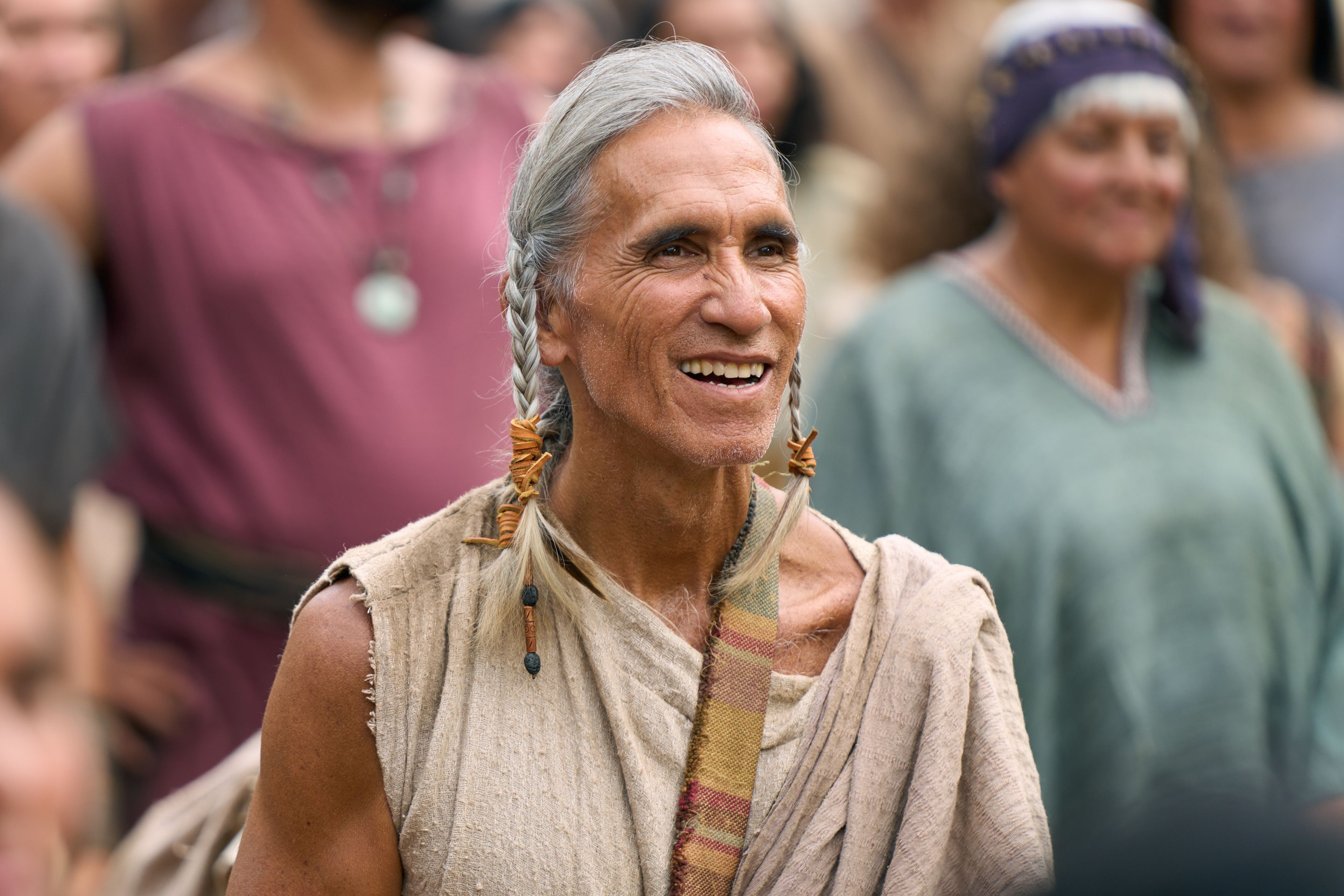 A man smiles as he watches the resurrected Savior, Jesus Christ, minister to the people in the ancient Americas.