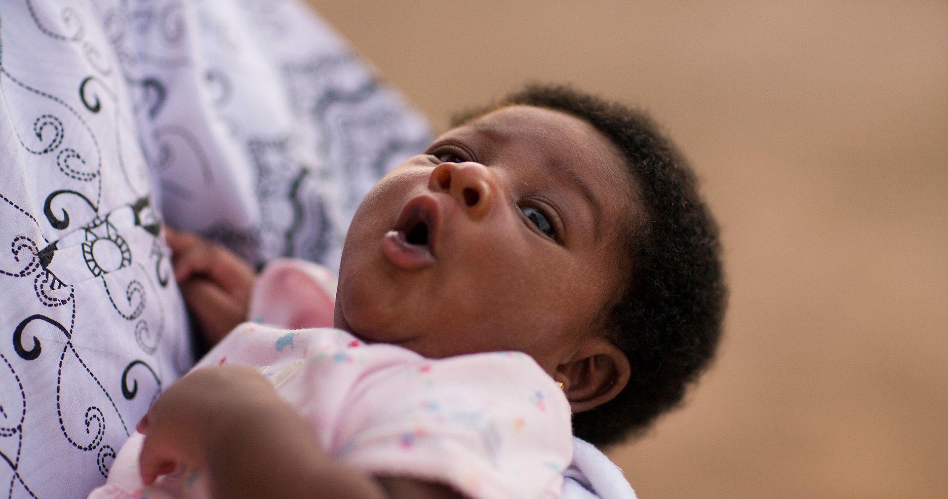 An infant being held