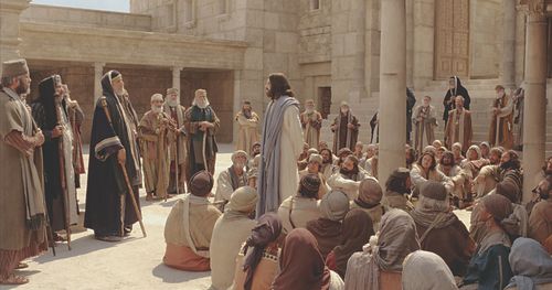 Jesus is shown with a group of people speaking to a scribe about the two great commandments. Outtakes: include close ups of people in the crowd. (Scene filmed at ext. the temple court of the Women)