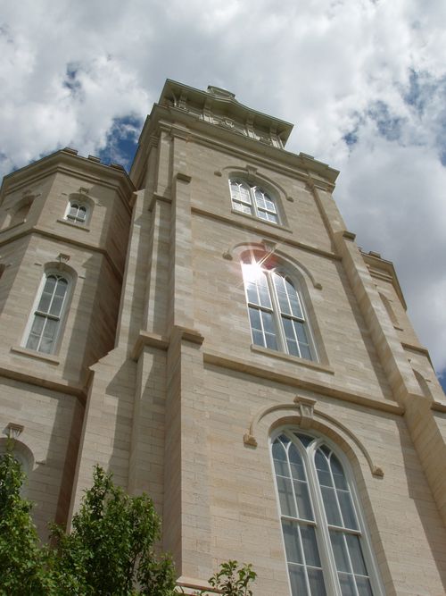 A low-angle view of the sun’s reflection on a window of the Manti Utah Temple.