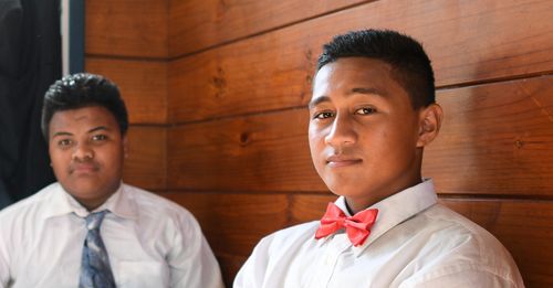 Two young men in dress shirts and ties.