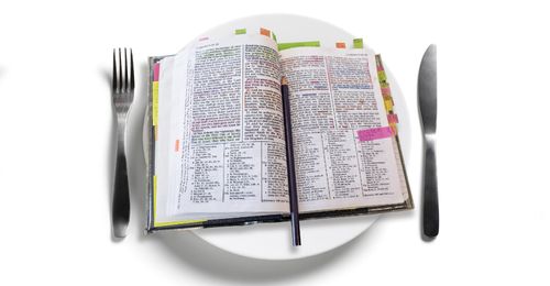 scriptures on a plate with utensils