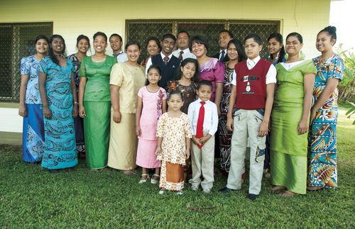 photo of a family standing together in front of chapel