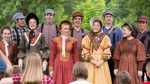 Young female and male missionaries singing songs while in pioneer clothing. 