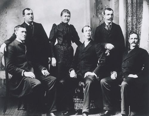 George Albert Smith sitting next to his wife, Lucy, who is standing near others at a missionary conference in Chattanooga, Tennessee, in 1893.