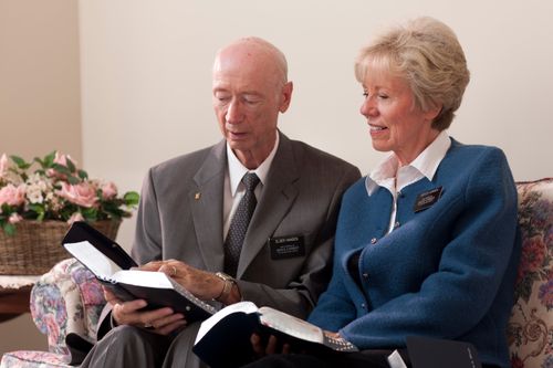 A senior missionary couple reading the scriptures.