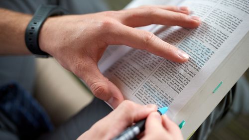 person marking scriptures