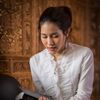 woman holding scriptures and praying