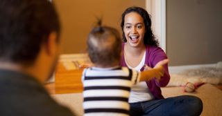 a toddler takes first steps