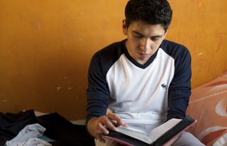 teenage boy studying scriptures