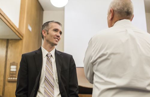 two men talking at church