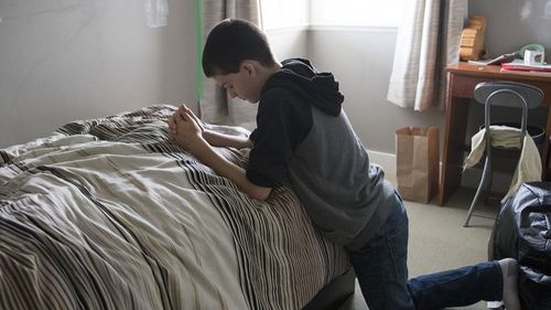 boy kneeling in prayer