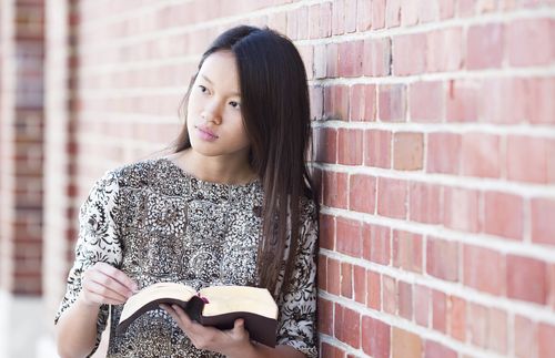 young adult woman reading scriptures