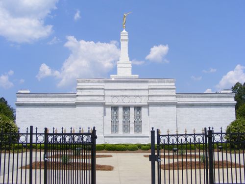 Windows on the side of the Raleigh North Carolina Temple, with a view of the fence around the grounds of the temple.